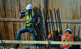 A construction worker drinks water during a break